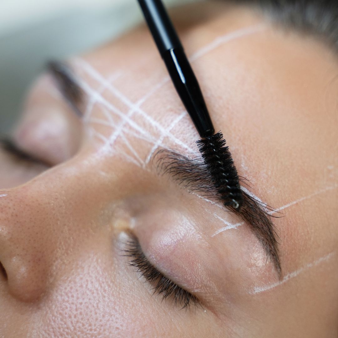 Brows being brushed after being mapped out
