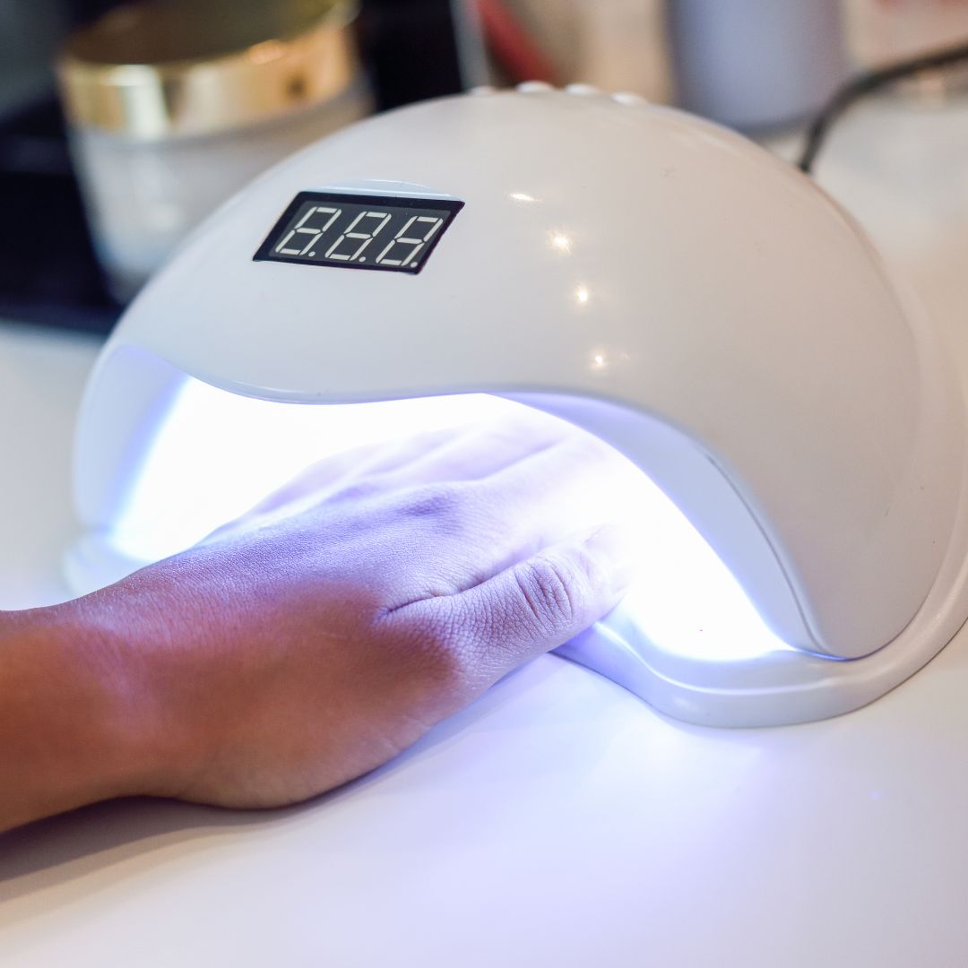 A hand in a nail lamp