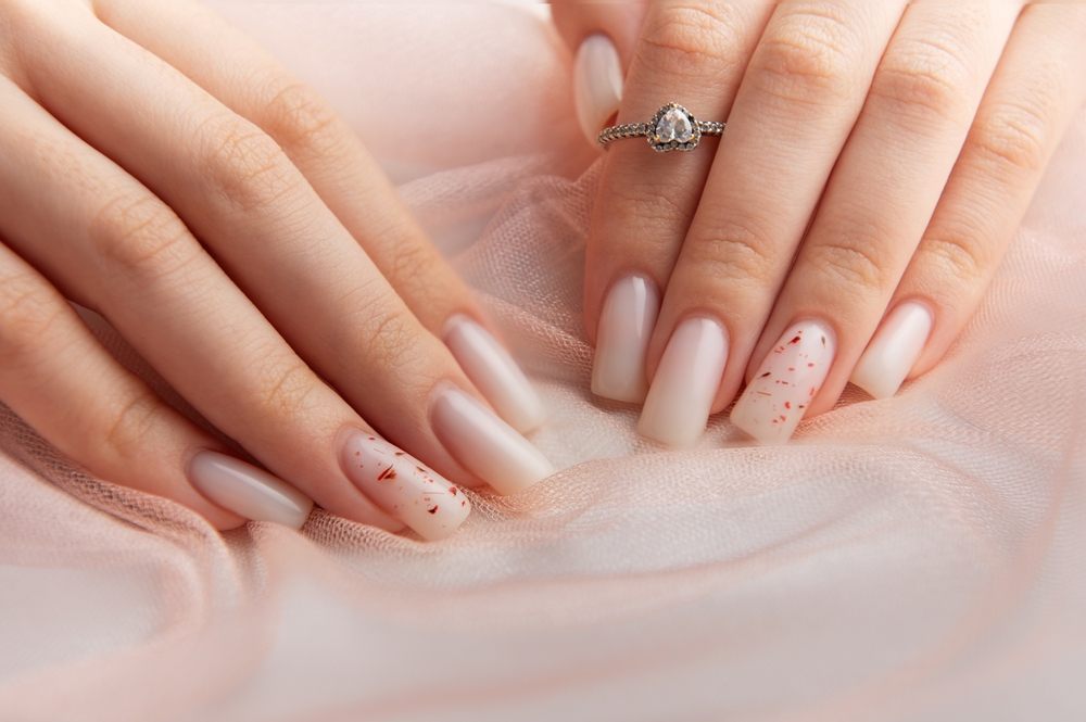 woman,showing,stylish,white,ombre,nails,with,red,glitter,and