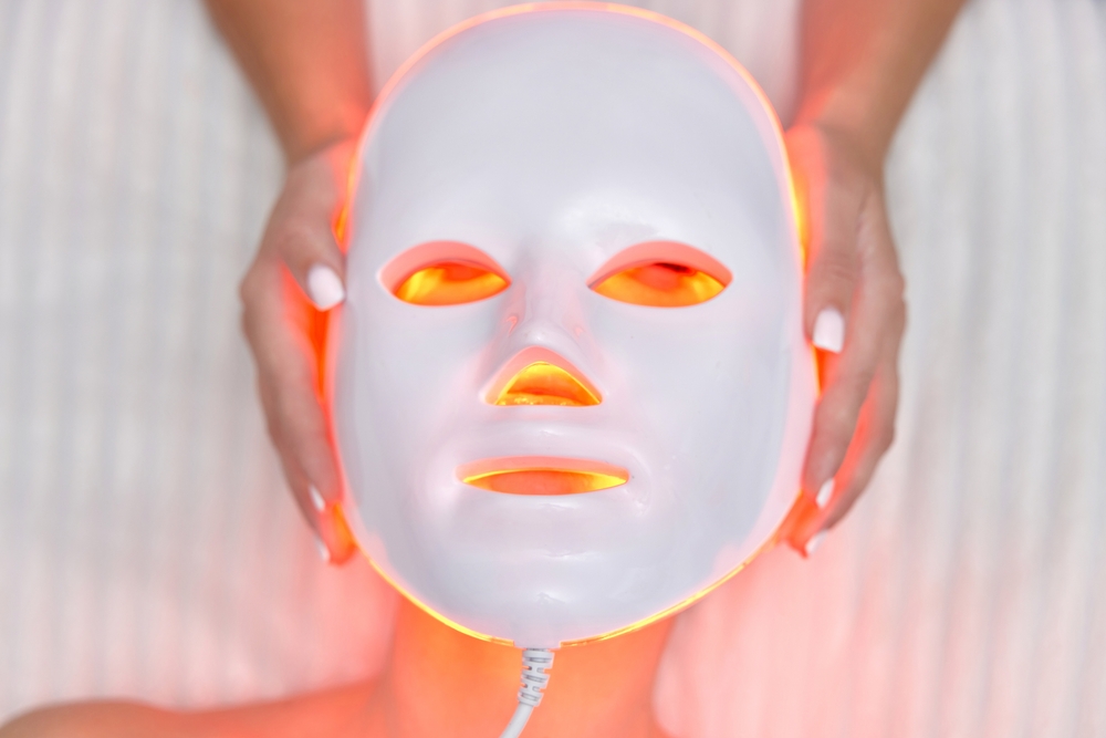 woman,getting,cosmetic,procedure,with,led,anti aging,facial,mask,in