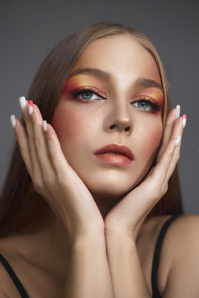 young,woman,demonstrates,a,bold,and,artistic,makeup,look,featuring