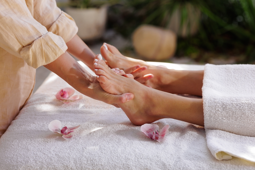 therapist,performs,soothing,foot,reflexology,on,a,spa,table,outdoors